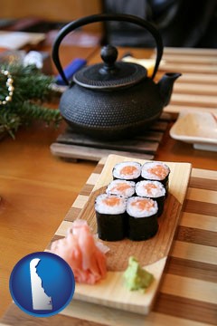 sushi and green tea being served at a Japanese restaurant - with Delaware icon